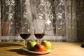 two glasses of wine with fruit on the table warm winter evening Royalty Free Stock Photo