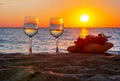 Two glasses of wine and grapes on sandy beach at sunset, Sicily island, Italy Royalty Free Stock Photo