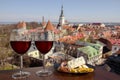 Two glasses of wine with mixed snacks against view from above of historic old town in Tallinn. Glass of red wine with different Royalty Free Stock Photo