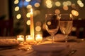 Two glasses of wine placed on a table in a romantic dinner setting, A romantic dinner setting with candlelight Royalty Free Stock Photo