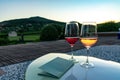 Two glasses of wine with an romantic view in Villany Hungary with Szarsomlyo hill and sunset