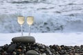 Two glasses of wine on stony beach Royalty Free Stock Photo