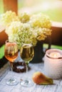 Two glasses of wine on summer table decorated with flowers. Royalty Free Stock Photo