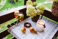 Two glasses of wine on summer table decorated with flowers. Royalty Free Stock Photo