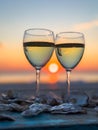Two glasses of wine at sunset with oyster shells on table Royalty Free Stock Photo