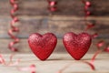 Two glitter hearts on vintage wooden table. Saint Valentines day greeting card. 14 February background.