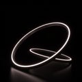 Two glowing rings float in a dark space, casting subtle reflections on the surface. The Royalty Free Stock Photo