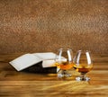 Two goblets of brandy and open book Royalty Free Stock Photo