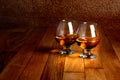 Two goblets of brandy on wooden counter top Royalty Free Stock Photo