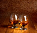 Two goblets of brandy on wooden counter top Royalty Free Stock Photo