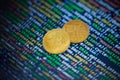 Two gold bitcoin coins on the background of lines of program code Royalty Free Stock Photo
