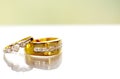 Two gold diamond wedding rings on white background.Golden Wedding Ring with Diamond on white background