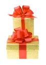 Two gold gift boxes with red ribbons Royalty Free Stock Photo