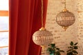 Two gold luxury classical electric chandeliers or lusters with crystal pendants in living room. Modern French interior with Antiqu