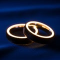 Two Gold Rings on Dark Blue Background Royalty Free Stock Photo