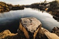 Two gold rings lying on a big gray stone. Nature. Basalt rock. Rock. Near the lake. rings lay on a stone on a background of lake Royalty Free Stock Photo