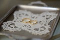 Two gold rings on a silver tray