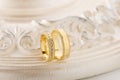 Two gold wedding rings on beige background Royalty Free Stock Photo