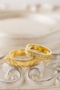 Two gold wedding rings on beige background Royalty Free Stock Photo