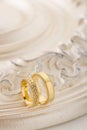 Two gold wedding rings on beige background Royalty Free Stock Photo