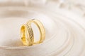 Two gold wedding rings on beige background Royalty Free Stock Photo