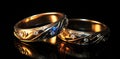 Two gold wedding rings with diamonds on a black background Royalty Free Stock Photo