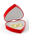 Two gold wedding rings lying in a red heart-shaped box. Royalty Free Stock Photo