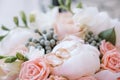 A pair of classic gold wedding rings sits on the bride`s bouquet of pink roses Royalty Free Stock Photo