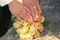 Two gold wedding rings on roses bouquet Royalty Free Stock Photo