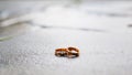 Two gold wedding rings on a stone surface, frontal view. Wedding, marriage, love concept. Royalty Free Stock Photo