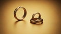 Two Gold Wedding Rings on Surface Royalty Free Stock Photo