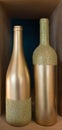 Two golden bottles for wine or beverages isolated