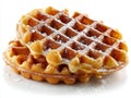 Golden brown Brussels waffles dusted with powdered sugar on a white background with soft lighting Royalty Free Stock Photo