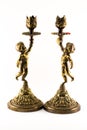 Two golden candlesticks in a form of a little boy with decorations