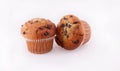 Two golden chocolate chip muffins against white background Royalty Free Stock Photo
