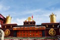 Two golden deer flanking a Dharma wheel on Jokhang