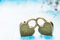 Two golden heart padlocks on wooden backrgound Royalty Free Stock Photo