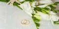 Two golden rings with bridal veil and flowers Royalty Free Stock Photo