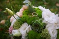 Two golden rings on a bride's wedding bouquet Royalty Free Stock Photo