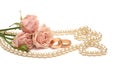 Two golden rings, pearls and flowers Royalty Free Stock Photo