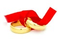 Two golden rings tied with red bow Royalty Free Stock Photo