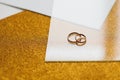 Two golden wedding rings on a golden background Royalty Free Stock Photo