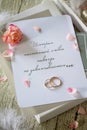 Two Golden Wedding Rings, box of chocolates and a wedding invitation Royalty Free Stock Photo
