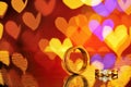 Two golden wedding rings with heart bokeh on background.Concept Royalty Free Stock Photo