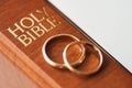 Two golden wedding rings and a holy bible represents the concept of marriage and the love between two Christians Royalty Free Stock Photo
