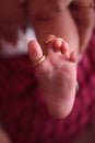 Gold wedding ring on a Tender cute foot of a just born baby