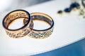 Two wedding rings with rare design on white broad ribbon