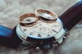 Two golden wedding rings on watch with brown strap Royalty Free Stock Photo