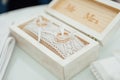 Two golden wedding rings in a wooden box on a soft pillow. Preparation for the ceremony. Royalty Free Stock Photo