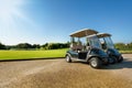 Two golf-carts standing at the parking in summer Royalty Free Stock Photo